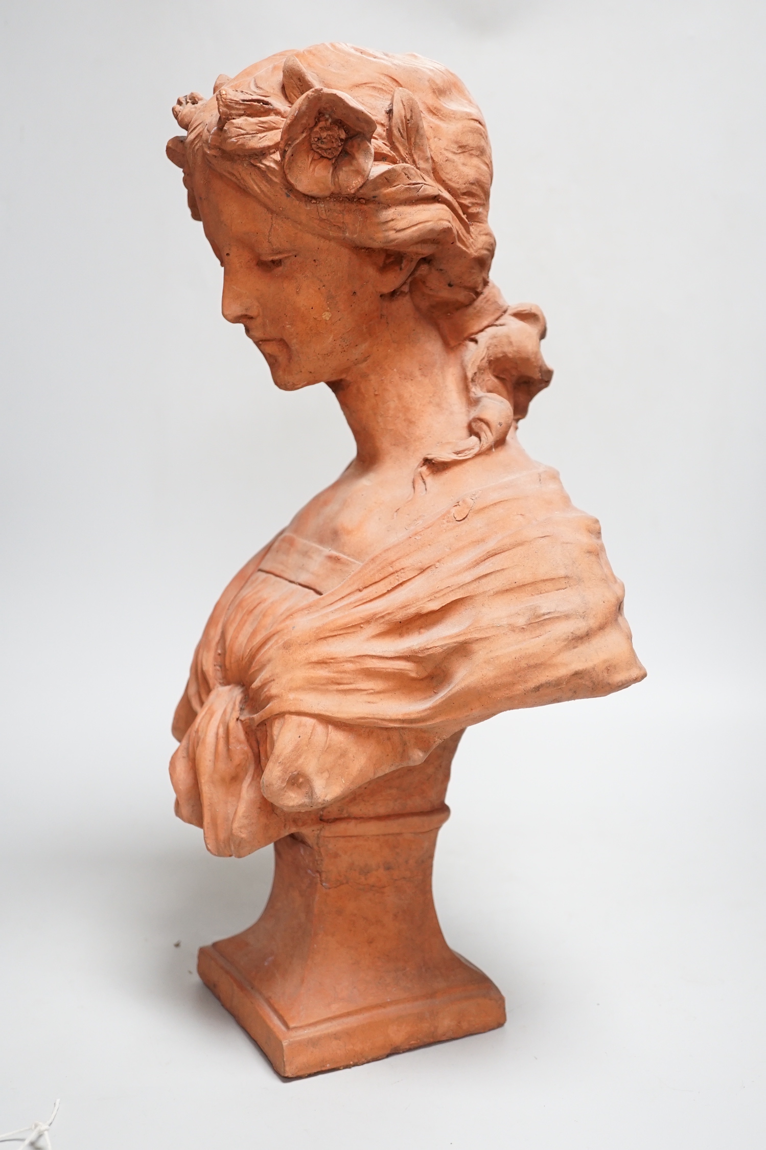 An Art Nouveau-style terracotta portrait bust of a young girl, 46cm high